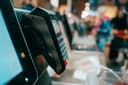 Card payment terminal at a busy retail checkout