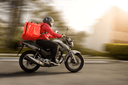 Delivery rider on a motorbike with an insulated delivery box