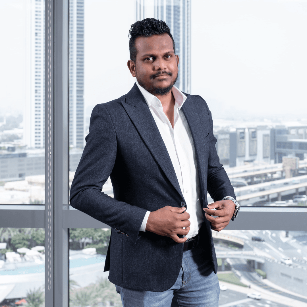 Piyath Garaka photographed in the Wizard office with the Dubai skyline behind
