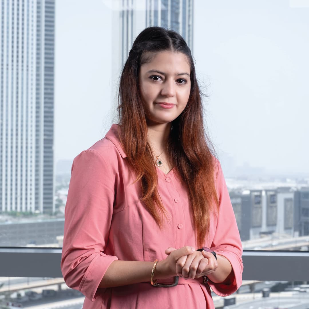 Raqeeba Nazir photographed in the Wizard office with the Dubai skyline behind